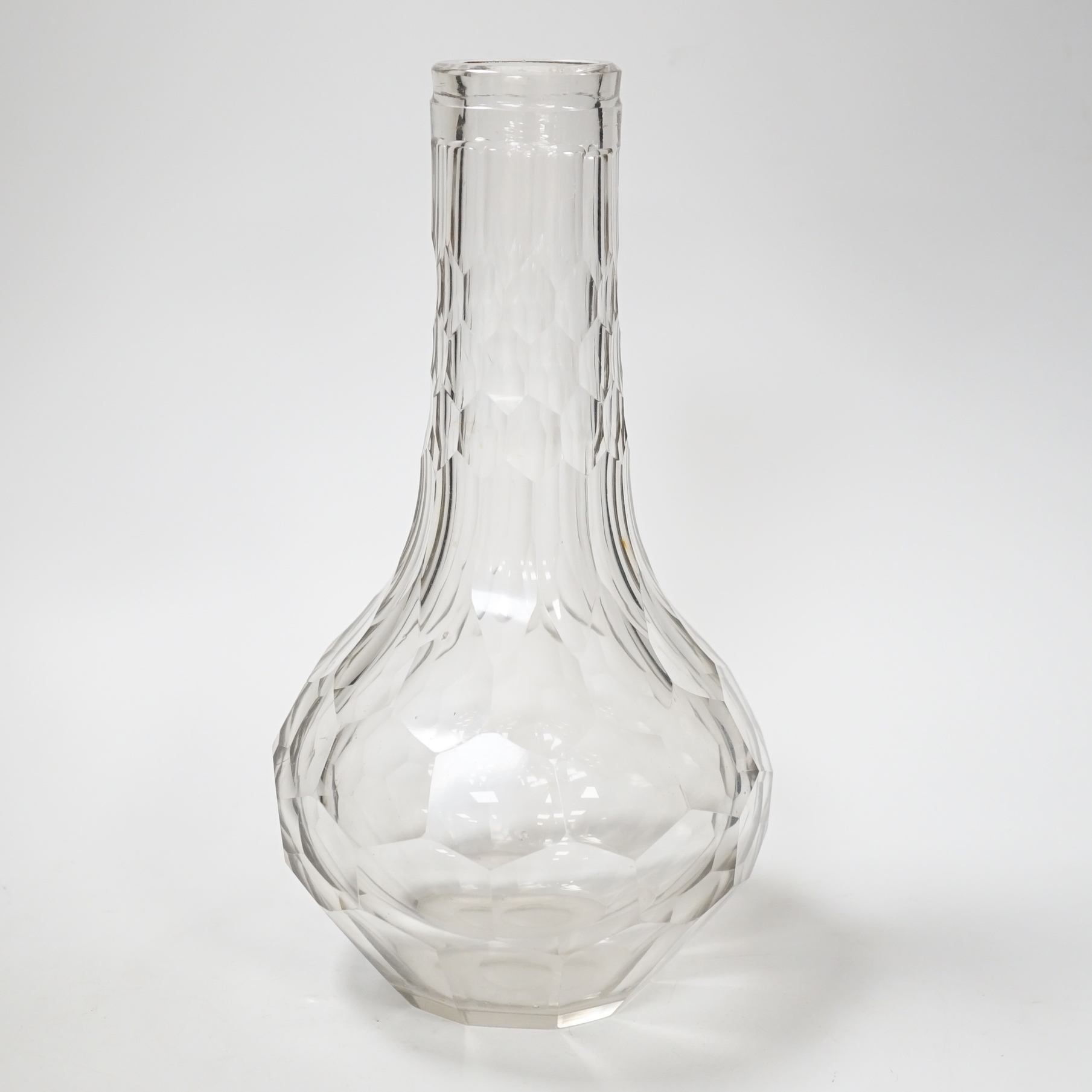 An English lead crystal facetted carafe, 18th century, the whole of the shaft and globe form is decorated with short and long hexagonal facets, the pontil is ground and polished, fine lilac tinge to metal, 28cm high